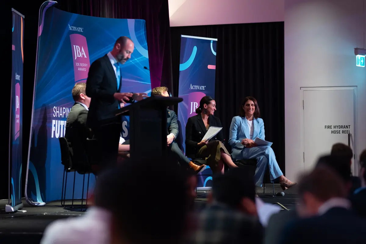 Industry leaders sharing their perspectives on stage at the Joe Berry Award